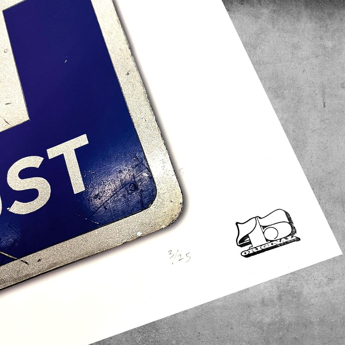 A close-up of the RocknRoad Sign Print - Exit Planet Dust by My Store shows a blue and white sign marked “ST,” set on a white surface with “3/25” handwritten for its limited edition and the AB ORIGINAL logo printed nearby.