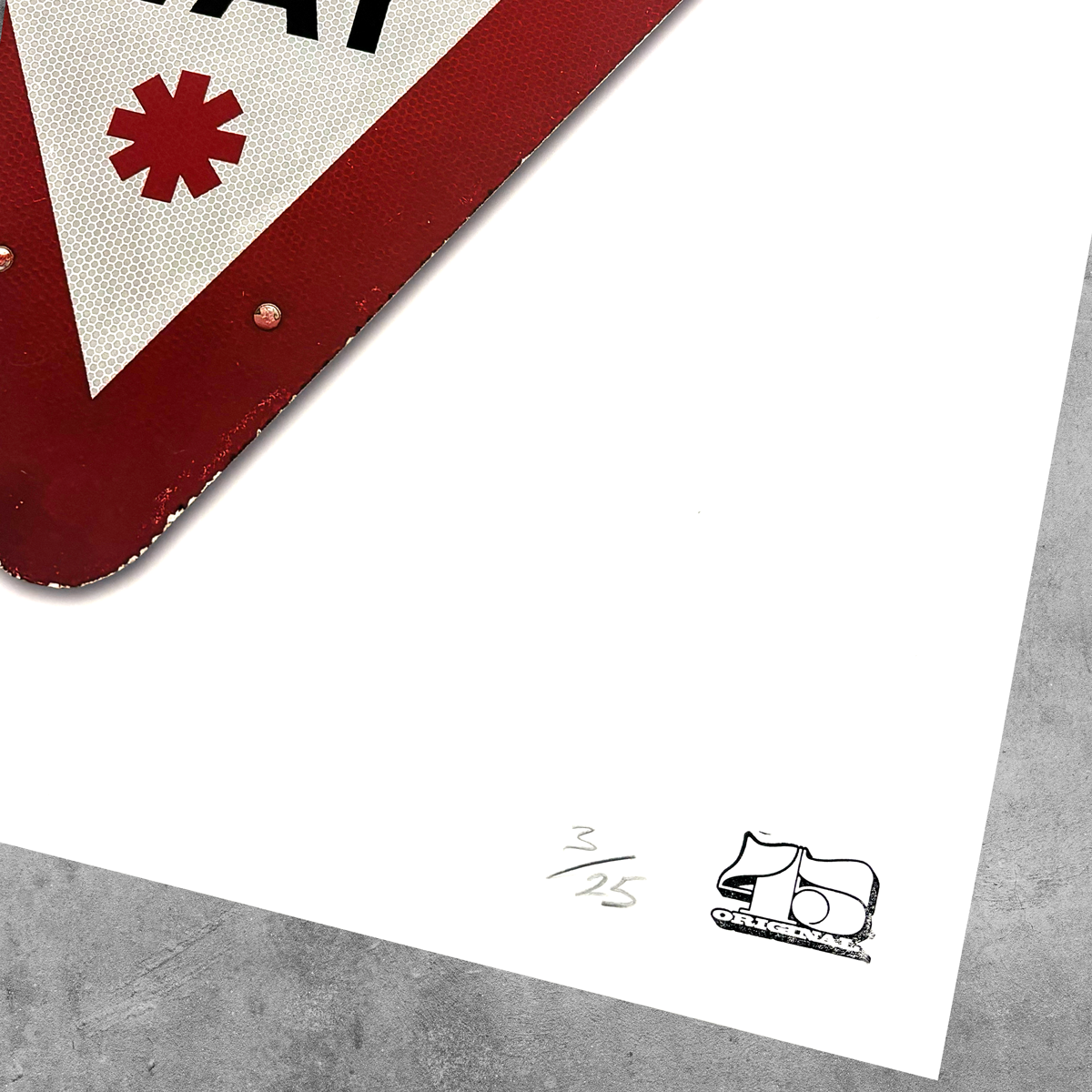A close-up of the RocknRoad Sign Print – Give It A Way by 45 Original, a limited edition UK road sign-inspired giclée print (3/25), with red and white design and a small black-and-white abstract logo in the corner.
