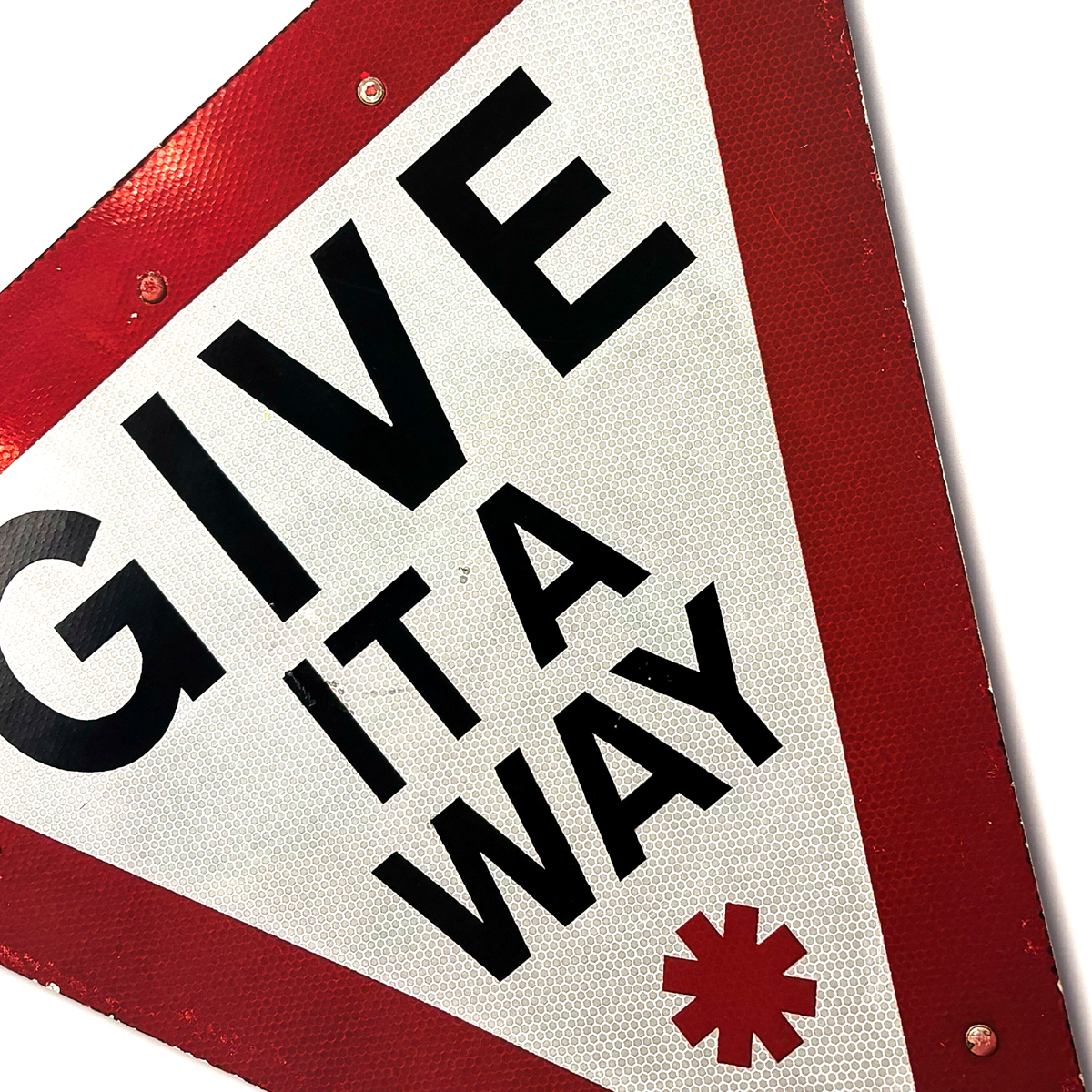 The RocknRoad Sign Print - Give It A Way by 45 Original is a limited edition of 25 featuring a triangular red and white UK road sign with GIVE IT A WAY in bold black letters and a red asterisk below—ideal for collectors.
