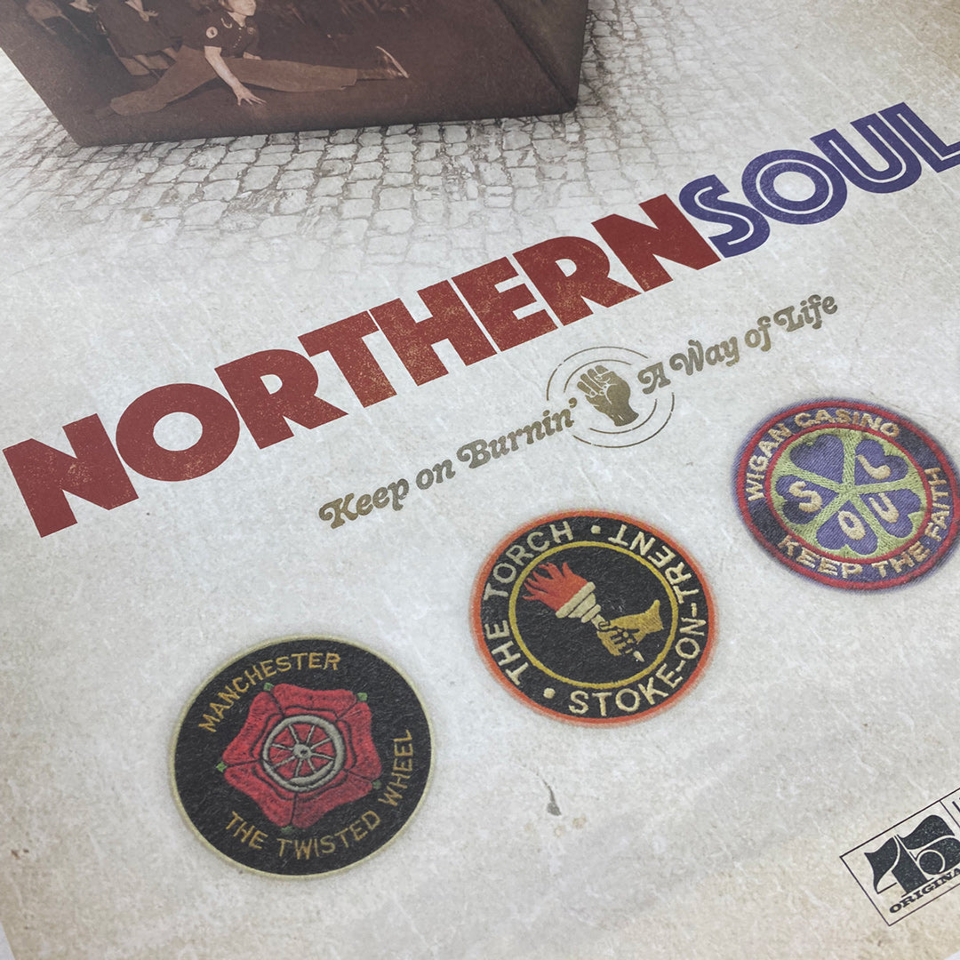 Close-up of the Northern Soul Poster Print by My Store, limited edition of only 100, showing bold red and blue text with vintage-style Manchester, Stoke-on-Trent, and Wigan Casino badges. Designed by Simon Collett.