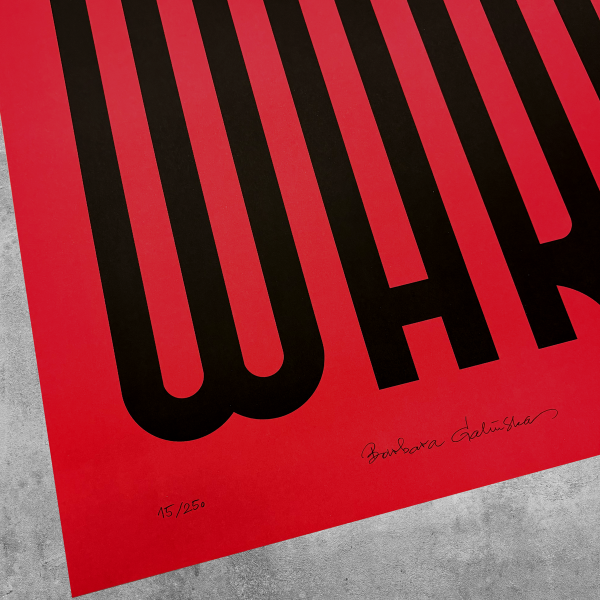 A striking close-up of the ‘Stop War’ Red And Black Print, limited to only 250 editions and featuring bold black WAR lettering, a signature, and edition details on a gray textured surface.