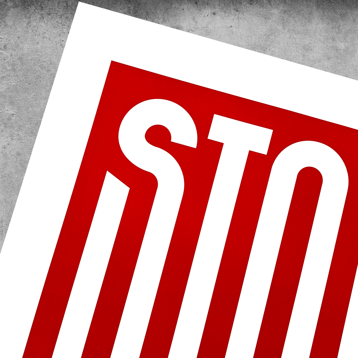 A close-up of the ‘Stop War’ Red And White Print – Limited Edition Of Only 250 by My Store shows large white STO letters on red, diagonally placed on a gray background, echoing the call to stop war with the word partially cropped.