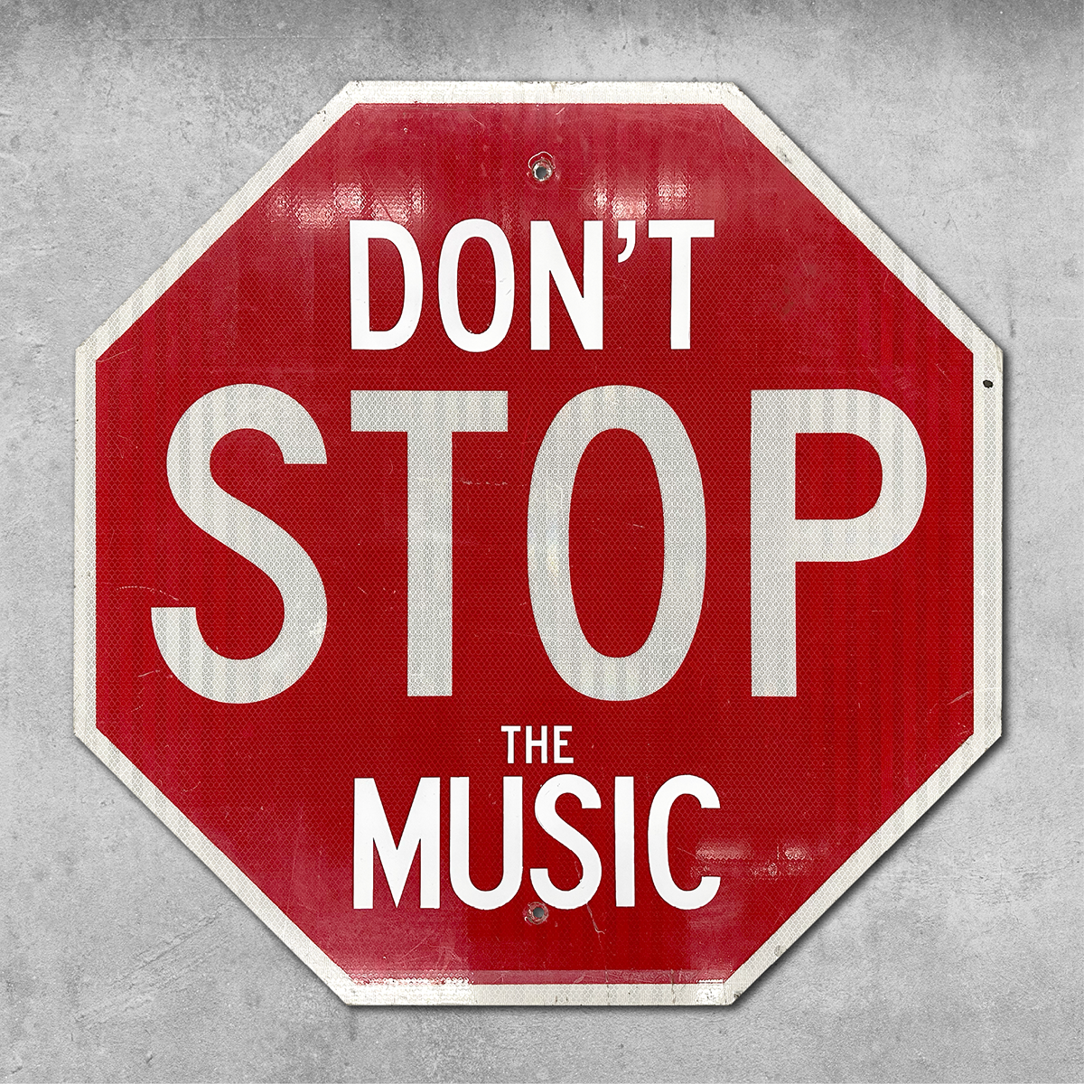 The 45 Original Original RocknRoad Sign - Dont Stop The Music is a red UK-style metal road sign with a reflective surface, mounted on a gray concrete wall, evoking the vibe of dance floors.