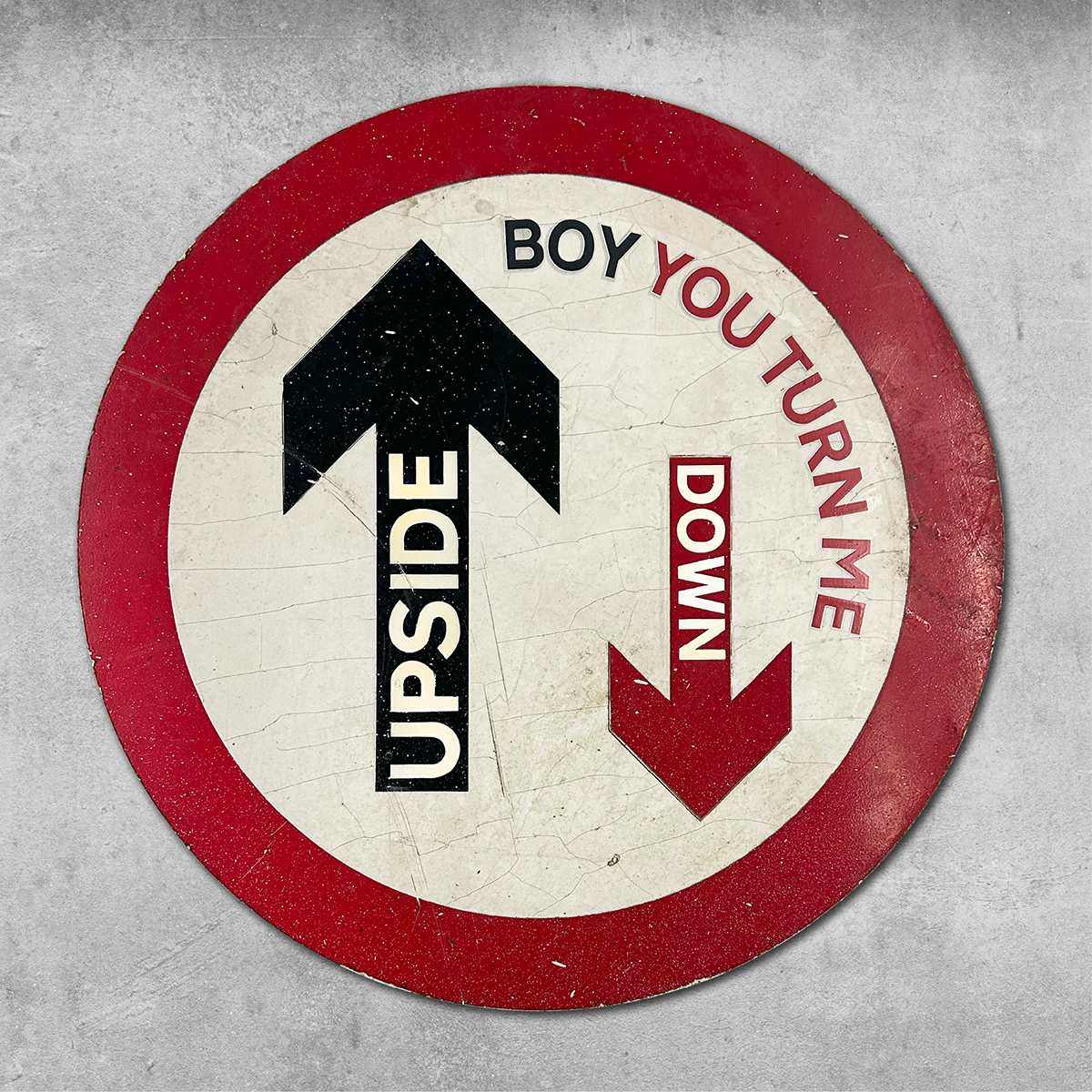 The 45 Original RocknRoad Sign - Upside Down is a round UK metal wall hanging with red and black arrows, “UPSIDE” and “DOWN,” plus the phrase BOY YOU TURN ME, playfully referencing Soul Disco Divas on a gray background.