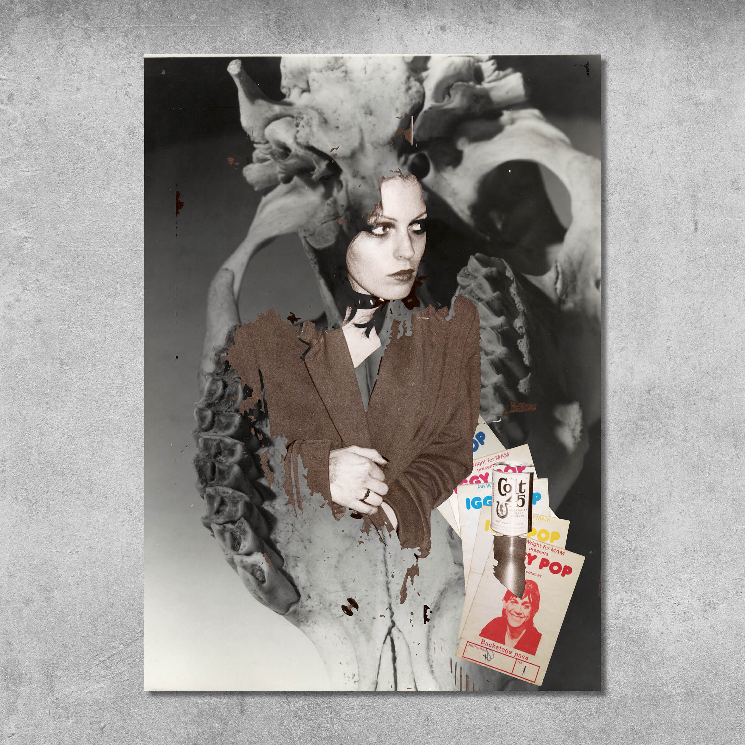 A woman in a brown jacket stands before a skull in this striking black-and-white 45 Original poster print, Memorabilia 7 (Gaye Advert/Skull), signed by Gaye Black—ideal for any collection. Vintage magazines stack at the corner.