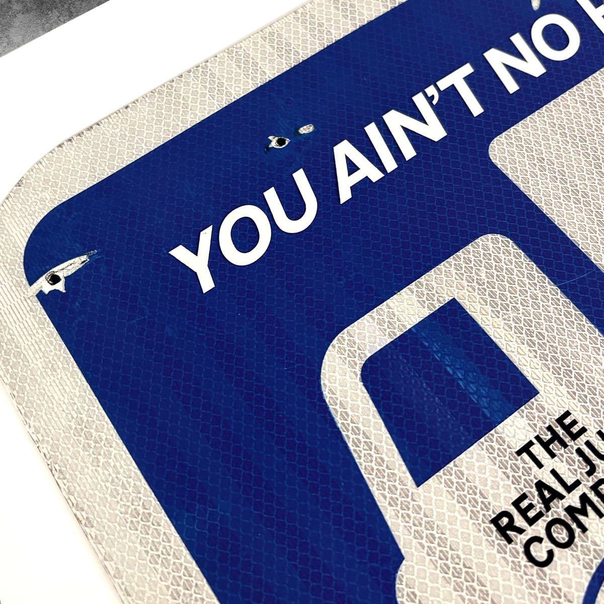 A close-up of the RocknRoad Sign Print - Garbageman by 45 Original shows YOU AINT NO in bold on a distressed blue and white sign. Available as a full colour giclée, this limited edition print is 1 of only 25 made.