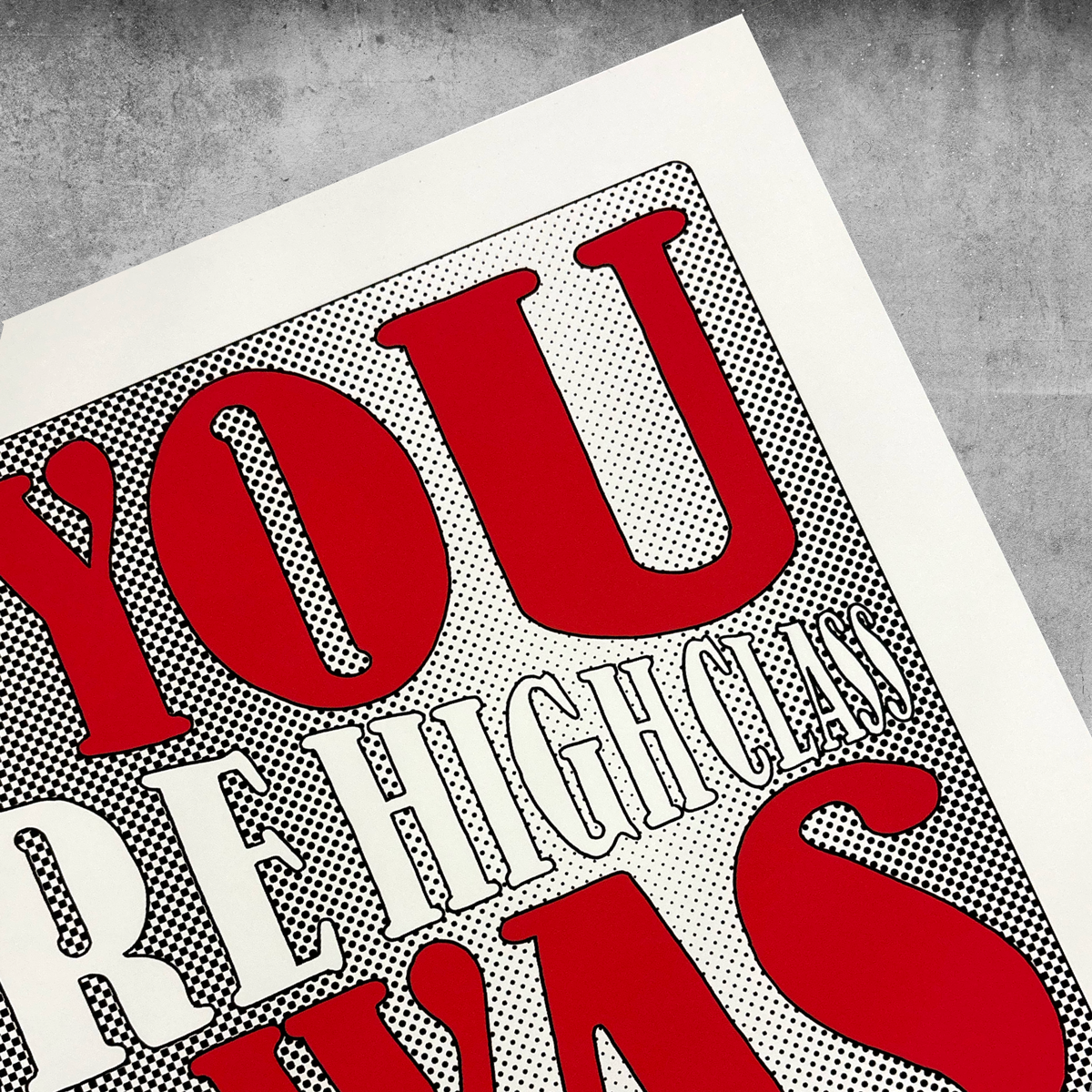 A close-up of My Stores Hound Dog Print—Limited Edition of Only 50—shows bold red and white “YOU” and “HIGH CLASS” letters on a dotted black-and-white background atop a textured gray surface.