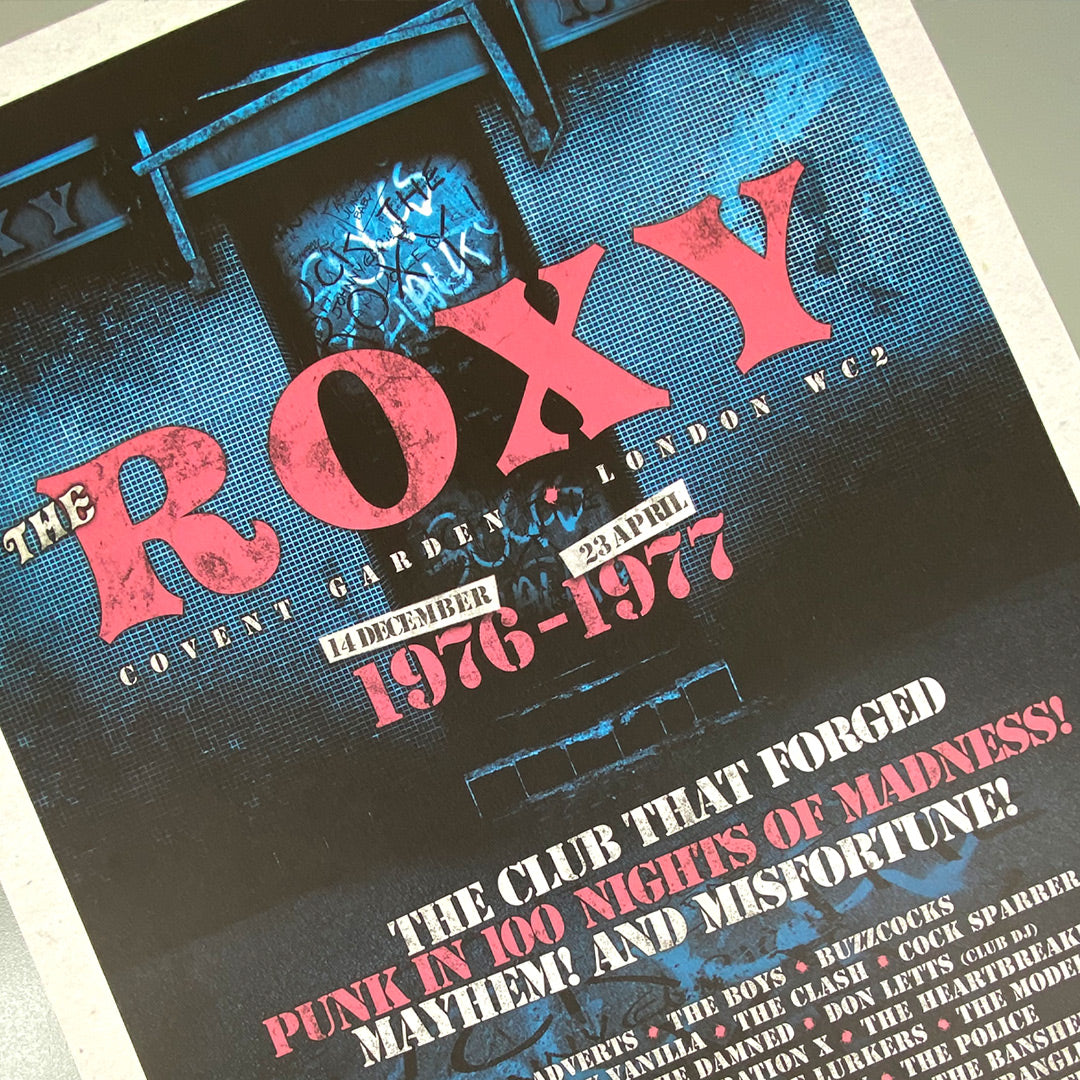The Roxy Club Poster Print by My Store is a limited edition of only 100, featuring bold pink and white text on blue, celebrating the punk scene (1976-77) and legendary bands—a must-have for music fans.