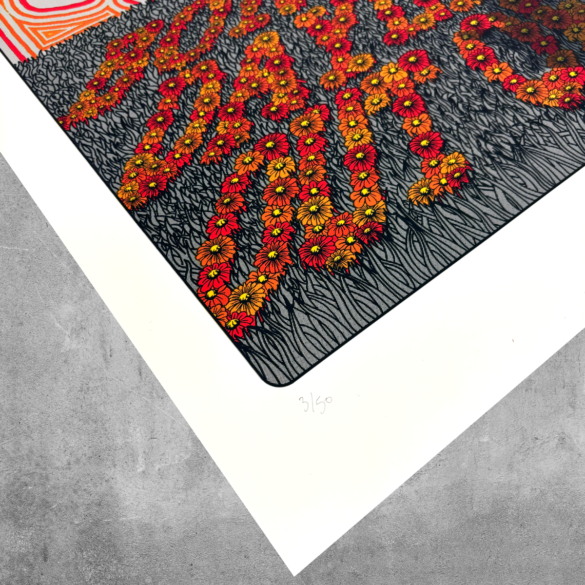 A close-up of My Store’s Sunshine Bores the Daylights Out of Me Print (limited edition of 50), showing bold red and yellow flower shapes forming words on a black wavy background, numbered “3/50” on a white border atop gray concrete.