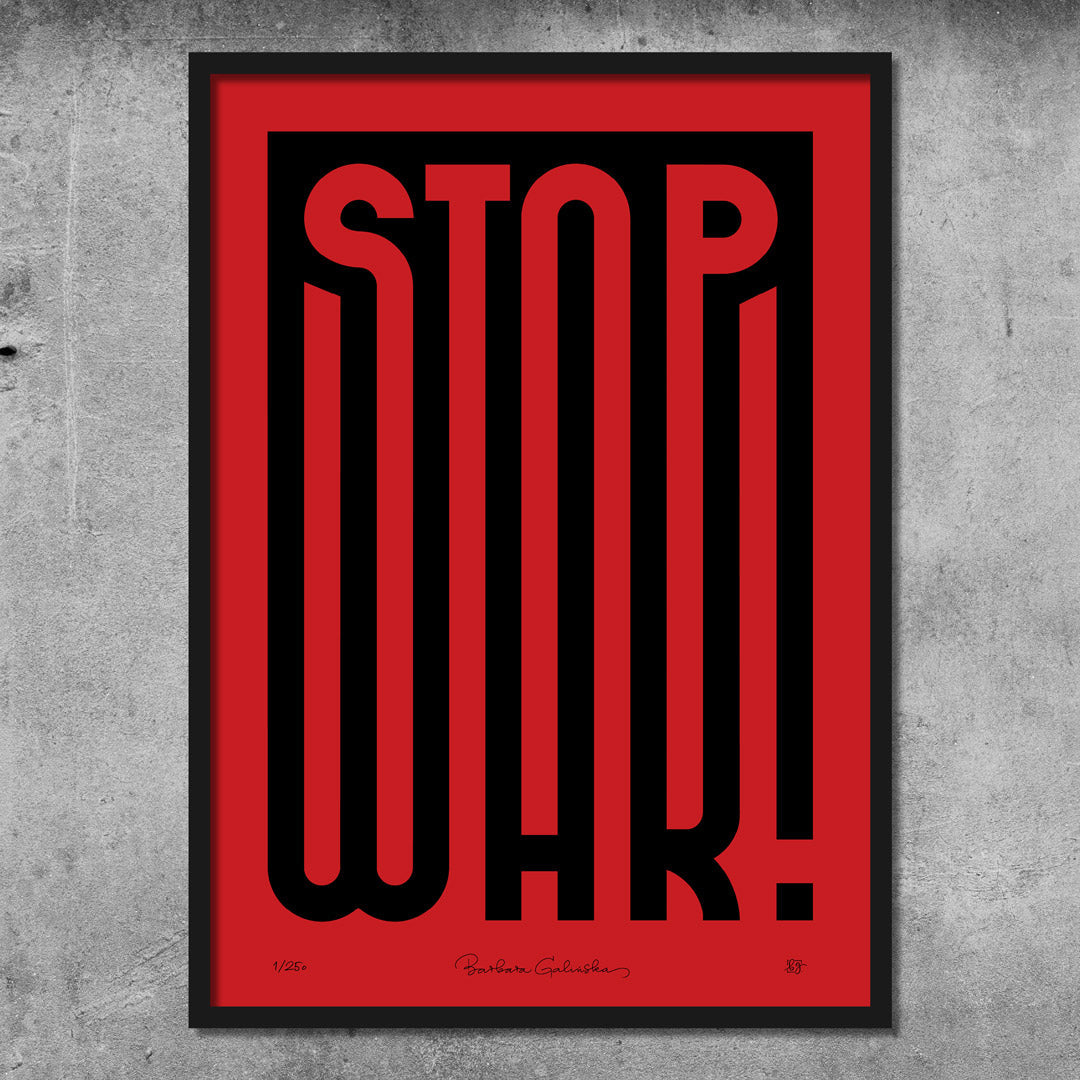 The ‘Stop War’ Red And Black Print – Limited Edition Of Only 250 features bold black text on red in a modern font, designed by Barbara Galińska. Framed poster creates striking impact against a concrete wall.